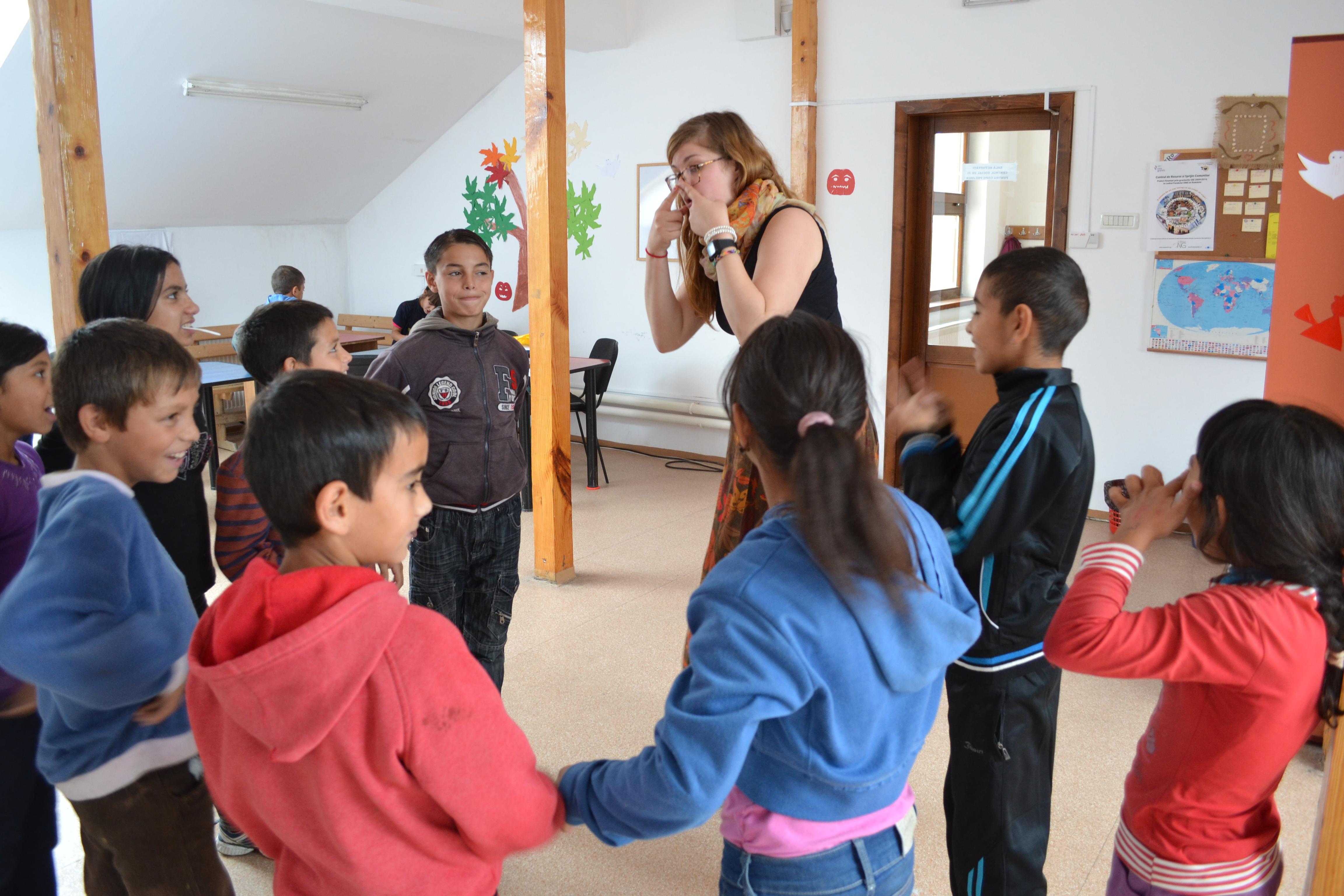 Female volunteer with children in Romania does a drama activity at a care centre during her Childcare Project. Children participate in a drama activity led by a Projects Abroad Childcare volunteer at a care centre in Romania.